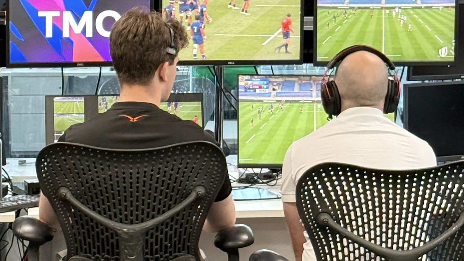 Two Television Match Officials review rugby footage across multiple screens